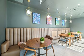 A dining room with tables and chairs and blue walls